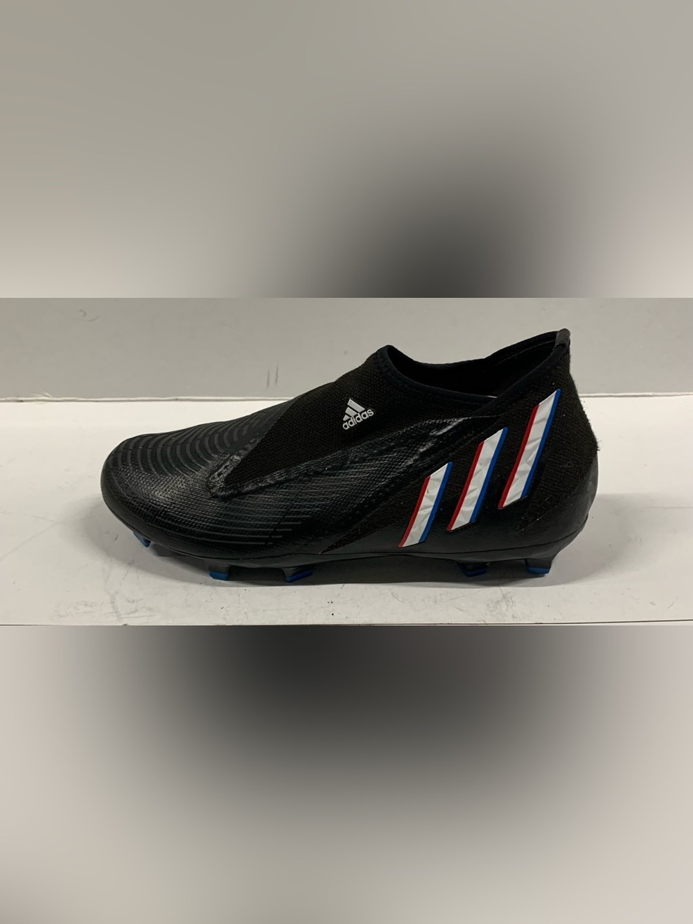 adidas Men’s Black Laceless Soccer Cleats with Red and Blue Stripes used